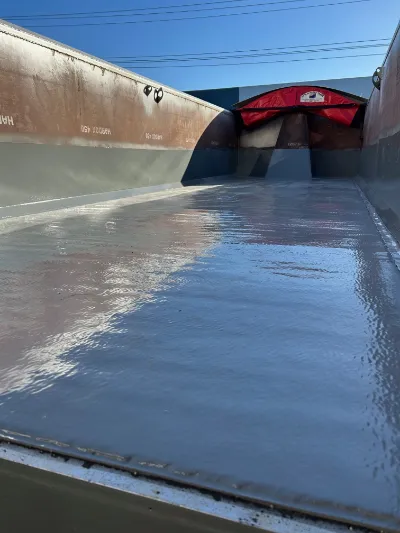 Slippery floor coating on a heavy transport tipper body